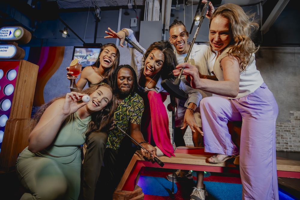 a group of friends enjoying themselves at Puttshack